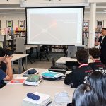 John Vargas visits Mara Aleardi's Economics class